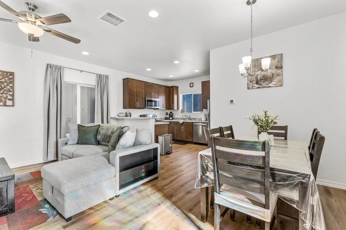 An open-concept kitchen and dining space with a welcoming atmosphere. The dining table is ready for shared meals, and the seating area offers a comfortable spot to gather, socialize, and recharge after exploring the outdoors.